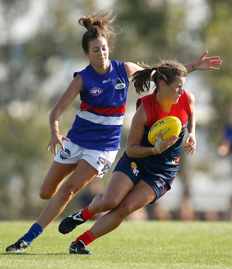 AFL 2016 Womens Exhibition - Western Bulldogs v Melbourne Alicia Eva (Demons) keeps out of reach of Steph Chiocci (Bulldogs) on Sunday - ${keywords}